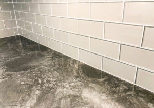 Grey countertop with white tile backsplash